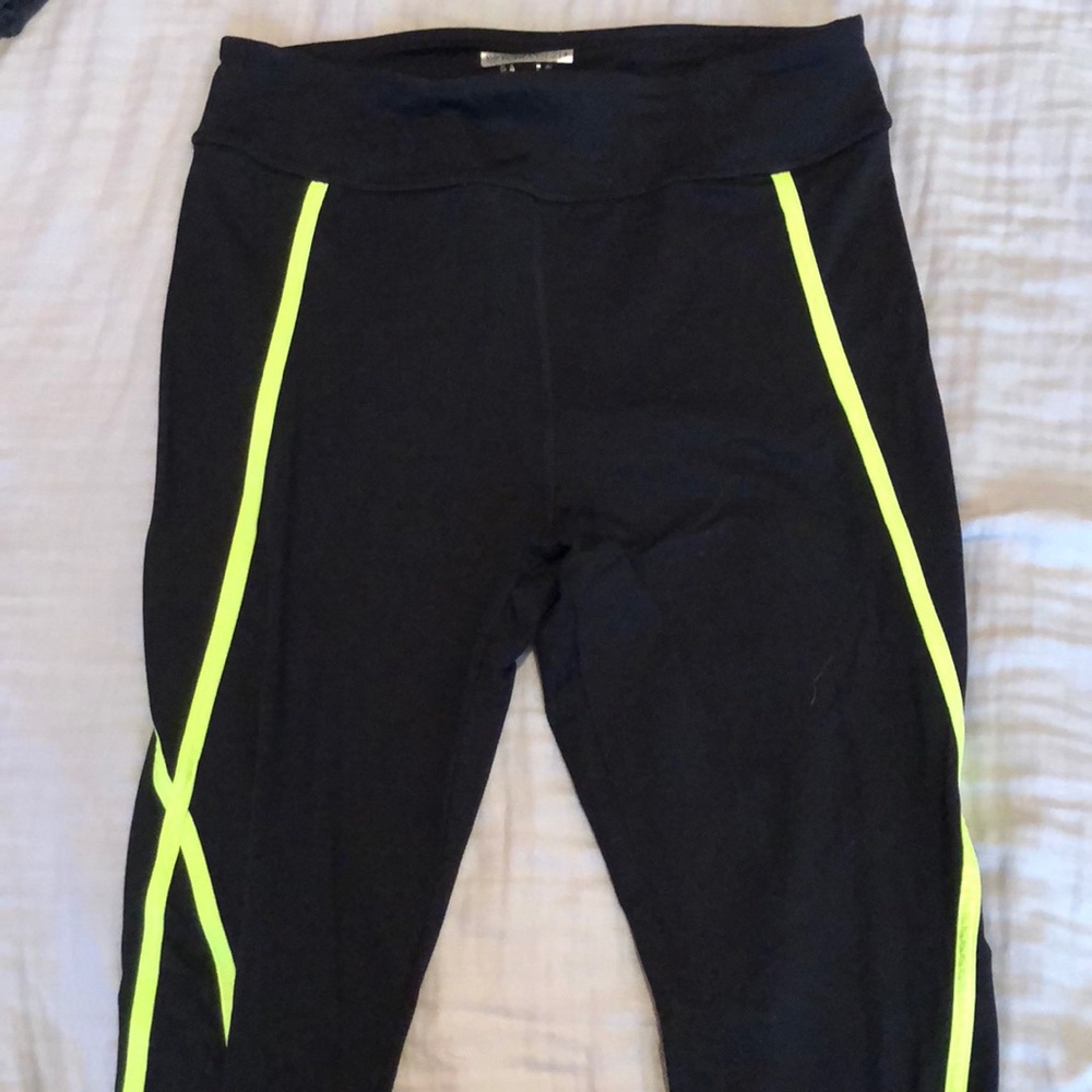 Black workout leggings with green X pattern on leg